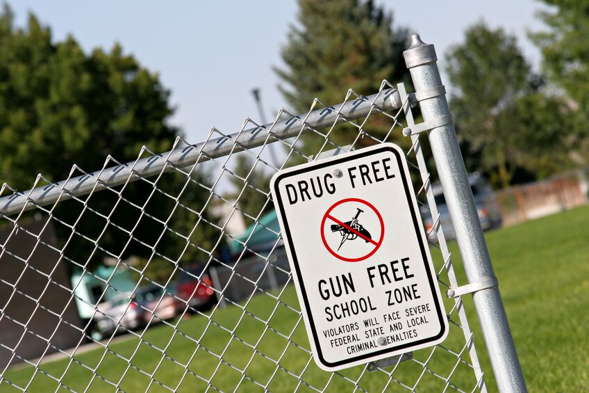 drug and gun free school zone sign at a school yard. 