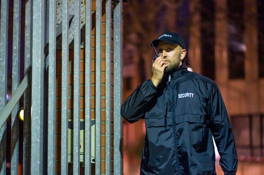 Security Guard At Entrance Gate At Night